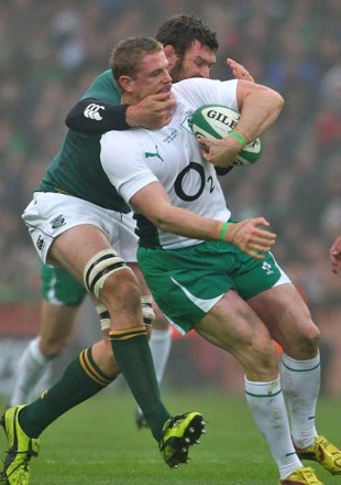 Ireland's Jamie Heaslip is tackles by South Africa's Danie Rossouw