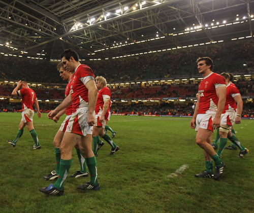 Dejected Wales players troop from the field 