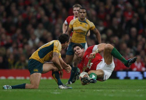 Wales fullback James Hook is levelled by Quade Cooper