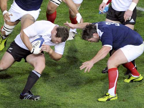 New Zealand's Tony Woodcock takes on France's Sylvain Marconnet
