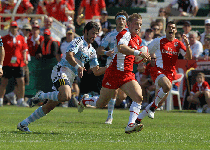 England's Jake Abbott escapes the Argentina defenders during their Dubai Sevens clash