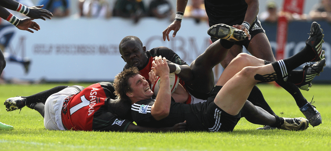 New Zealand's Kurt Baker is grounded by the Kenya defence