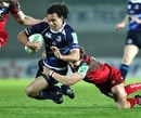 Leinster's Isa Nacewa is tackled by the Scarlets' Martin Roberts
