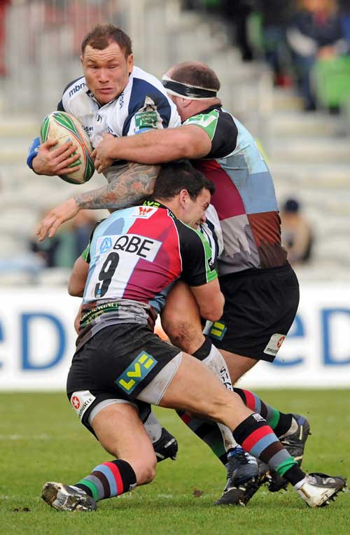 Sale's Lee Thomas is tackled by the Harlequins defence