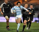 Racing Metro's Fabien Fortassin evades the tackle of Rugby Roma's Riccardo Casasanta