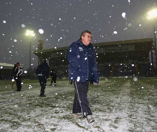 Harlequins coach John Kingston troops from a snowy Edgeley Park