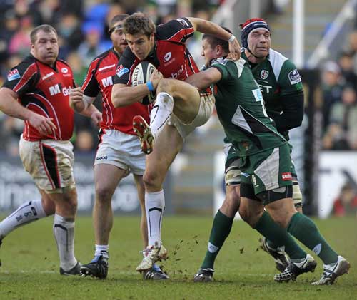 Saracens' Chris Wyles is held by the London Irish defence