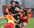 Toulouse centre Florian Fritz is wrapped up by the Perpignan defence