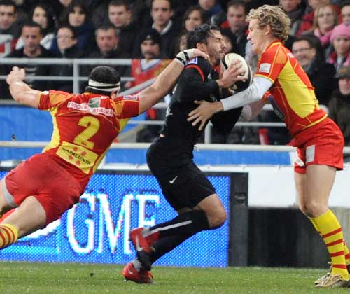 Toulouse fullback Clement Poitrenaud is caught by the Perpignan defence