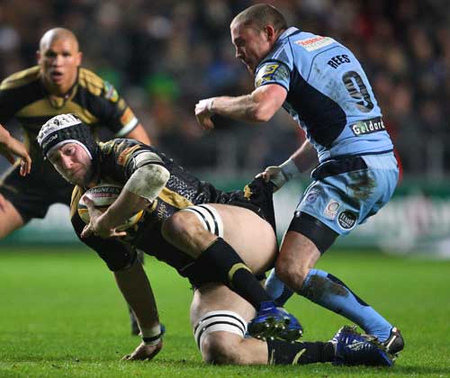 The Ospreys' Ryan Jones is tackled by the Blues' Richie Rees