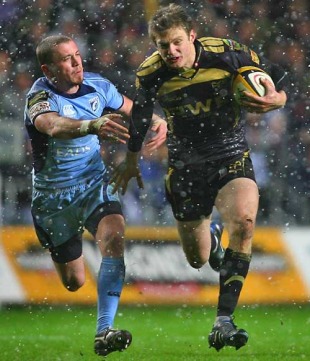 The Ospreys' Dan Biggar evades the challenge of the Blues' Richie Rees, Ospreys v Blues, Magners League, Liberty Stadium, Swansea, Wales, January 1, 2010
