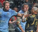 The Blues' Xavier Rush gets to grips with the Ospreys' Ricky Januarie