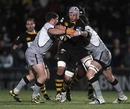 Wasps No.8 Dan Ward-Smith is wrapped up by Newcastle tacklers