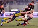 Toulouse's Louis Picamole is tackled by the Clermont defence