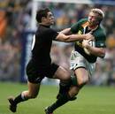 Jean de Villiers tries to pass Dan Carter