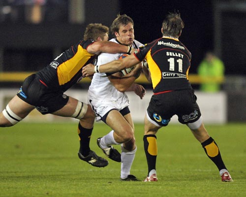 Newcastle's Will Welch is shackled by the Dragons' defence during an Anglo-Welsh Cup clash