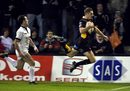 The Dragons' Jason Tovey scores goes airborne to score a try against Newcastle in the Anglo-Welsh Cup