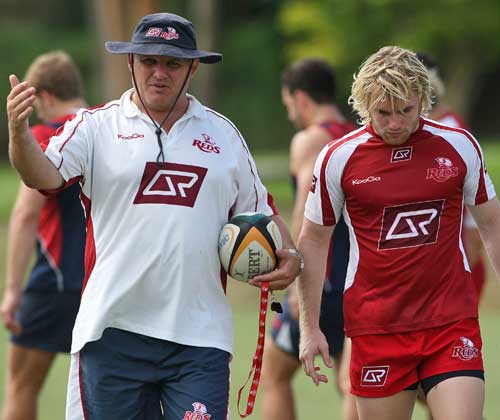 Reds coach Ewen McKenzie chats to Ben Lucas during a training session