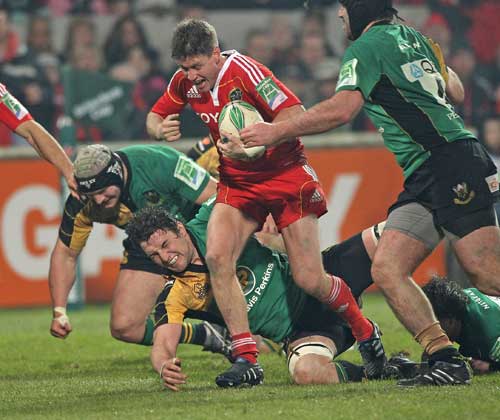 Munster's Ronan O'Gara takes on the Northampton defence