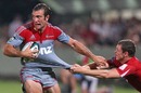 The Crusaders' Adam Whitelock stretches the Reds' defence