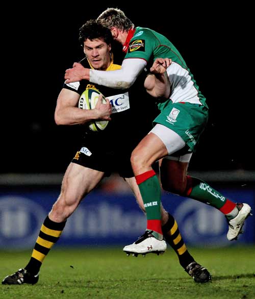Wasps' Ben Jacobs is tackled by the Scarlets' Gareth Maule