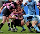 Newcastle's Adam Balding is tackled by the Blues' defence