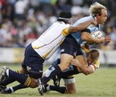 The Waratahs' Phil Waugh is hauled down by the Brumbies' defence