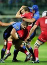The Reds' Luke Morahan is tackled by the Force's Matt Hodgson and Nathan Sharpe 