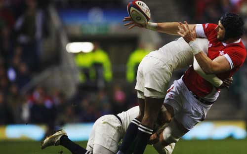Tom James is stopped in his tracks by the England defence