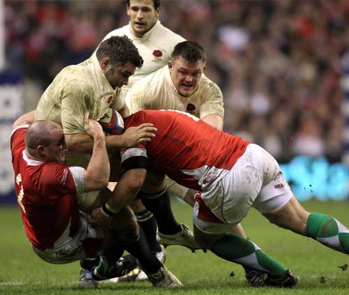 England No.8 Nick Easter is tackled by the Wales defence