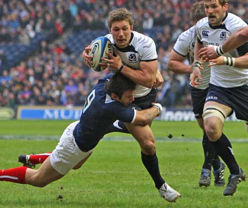 Scotland's Chris Cusiter is tackled by France's Morgan Parra