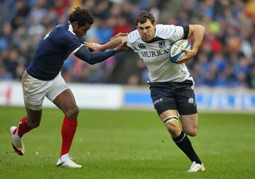 Scotland's Sean Lamont hands off France's Benjamin Fall