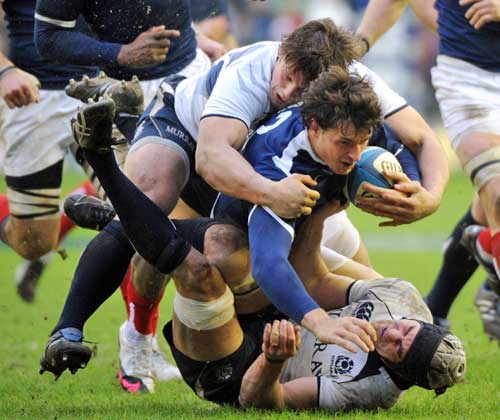 France's Yannick Jauzion is felled by the Scotland defence