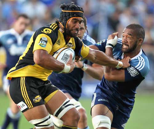 The Hurricanes' Victor Vito is tackled by the Blues' Viliami Ma'afu