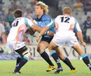 The Bulls' Wynand Olivier is tackled by the Cheetahs' Naas Olivier and Meyer Bosman