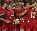 The Queensland Reds celebrate after Daniel Braid's early try