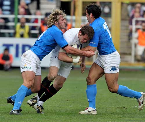 England's Mark Cueto is tackled by the Italy defence