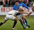 Italy's Andrea Masi is tackled by the England defence