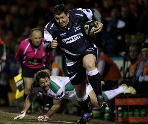 Sale prop Eifion Lewis Roberts powers past Andy Gomarsall