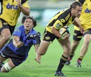 The Hurricanes' Aaron Cruden evades the Western Force's Sam Wykes