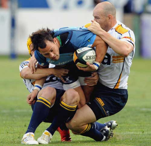 The Bulls' Francois Hougaard is tackled by the Brumbies' Stirling Mortlock and Matt Giteau