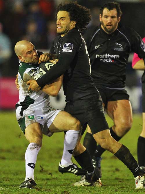 London Irish's Paul Hodgson is tackled by Newcastle's Tane Tu'ipulotu 