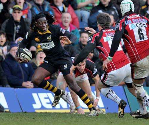 Wasps' Paul Sackey is pursued by the Saracens defence