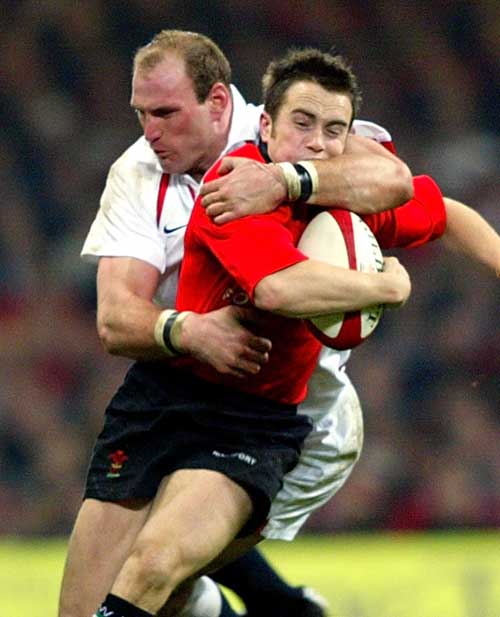 Wales' Rhys Williams is tackled by England's Lawrence Dallaglio