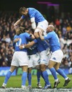 Italy wing Kaine Robertson is swamped after scoring Italy's third try