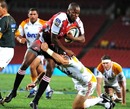 The Lions' Wandile Mjekevu is tackled by the Chiefs' Stephen Donald