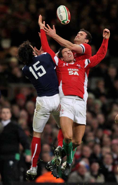 Wales' James Hook and France's Clement Poitrenaud compete for a high ball