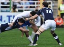 Italy fullback Luke McLean feels the force of the Scottish defence