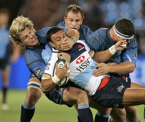 The Waratahs' Sosene Anesi is mobbed by the Bulls' defence