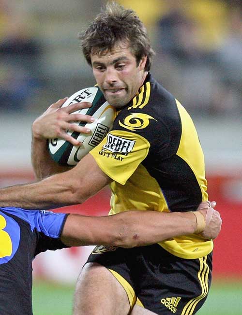 Hurricanes center Conrad Smith takes on the Western Force defence